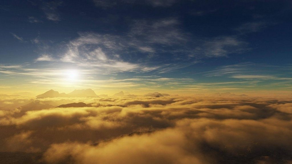 Tranquil sunrise over golden mist with glowing mountains and deep blue sky serene wallpaper