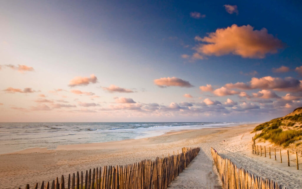Tranquil Beach Sunset Wallpaper: Scenic Ocean View Background