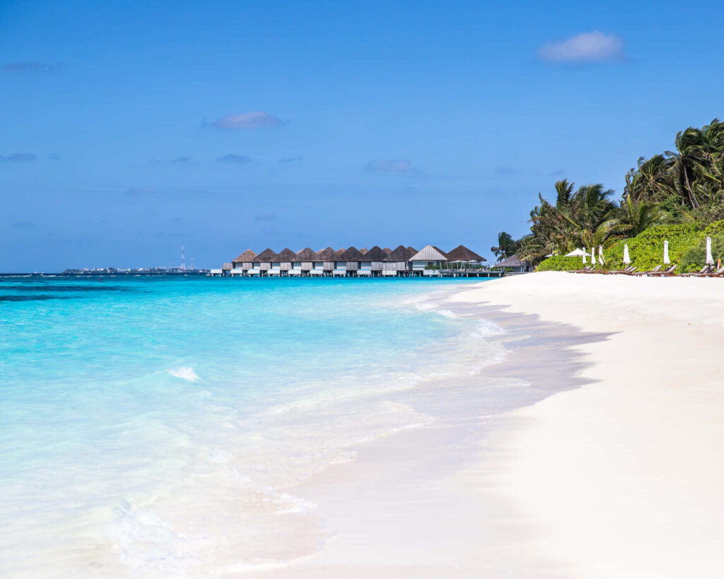 Pristine Beach Escape: Overwater Bungalows & Turquoise Waters Wallpaper