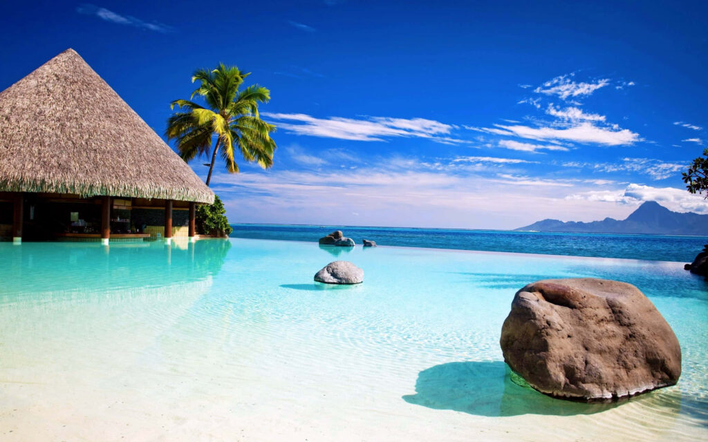 Tropical Paradise Wallpaper: Thatched Hut & Turquoise Waters Background