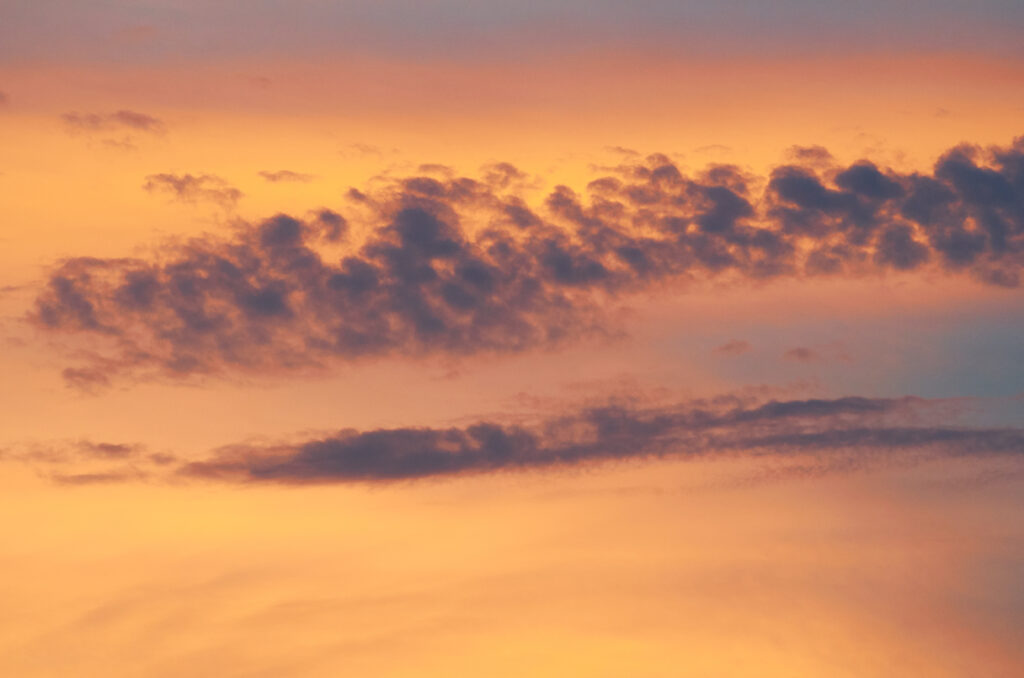 Twilight sky wallpaper with soft clouds and warm orange purple gradient for calm background