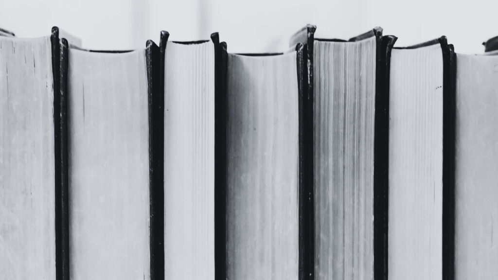 Tranquil Reading Under a Tree: Black & White Book Wallpaper
