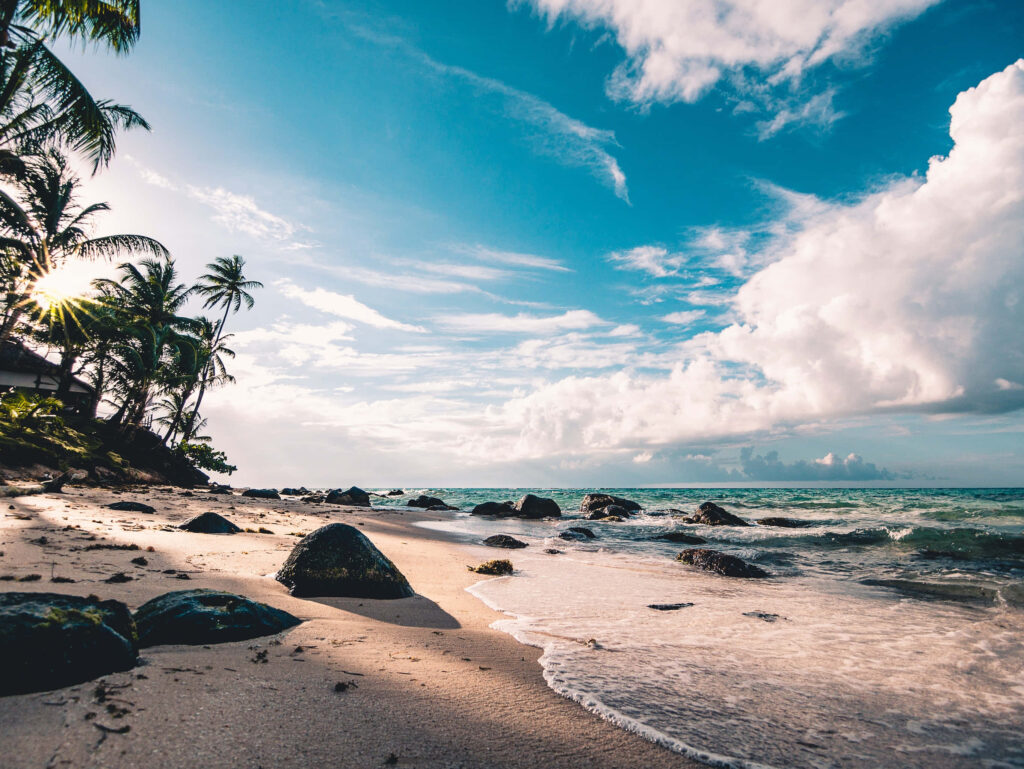Escape to Paradise: Unwind and Immerse Yourself in the Serenity of a Breathtaking Beachscape Wallpaper