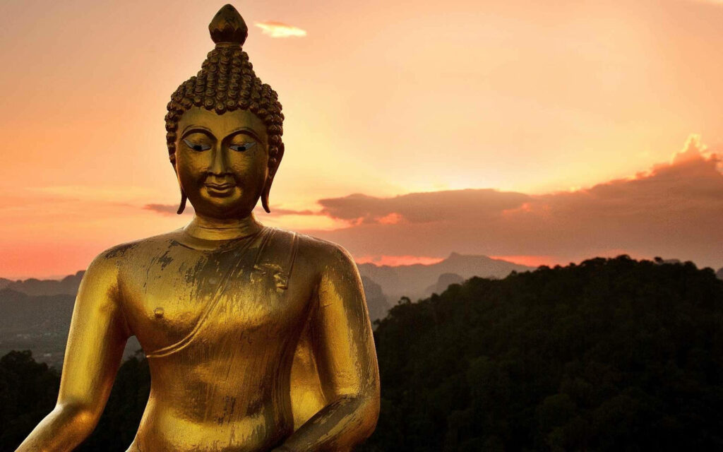 Serene Sunset: Captivating Golden Buddha against a Breathtaking Backdrop Wallpaper