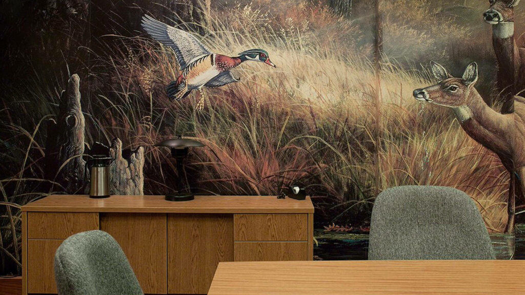 Rustic marshland mural with flying wood duck and deer in serene office with wood furnishings Wallpaper