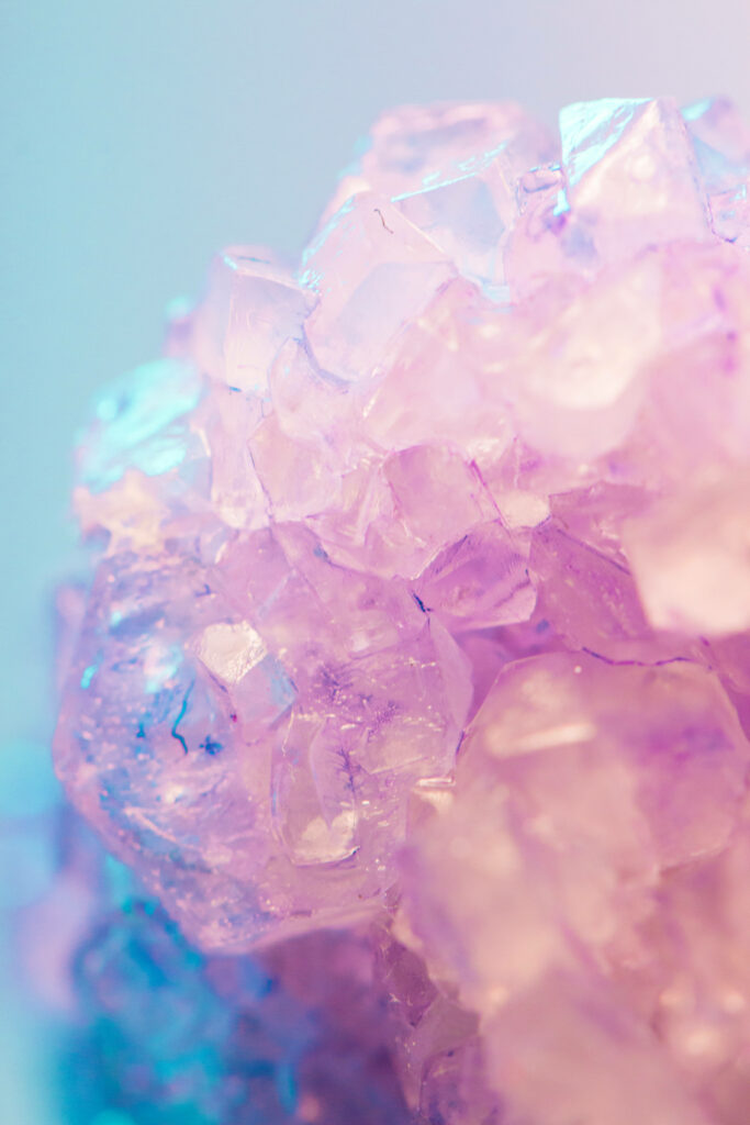 Close-up of translucent purple crystals with sparkling facets on a lavender blue gradient background Wallpaper