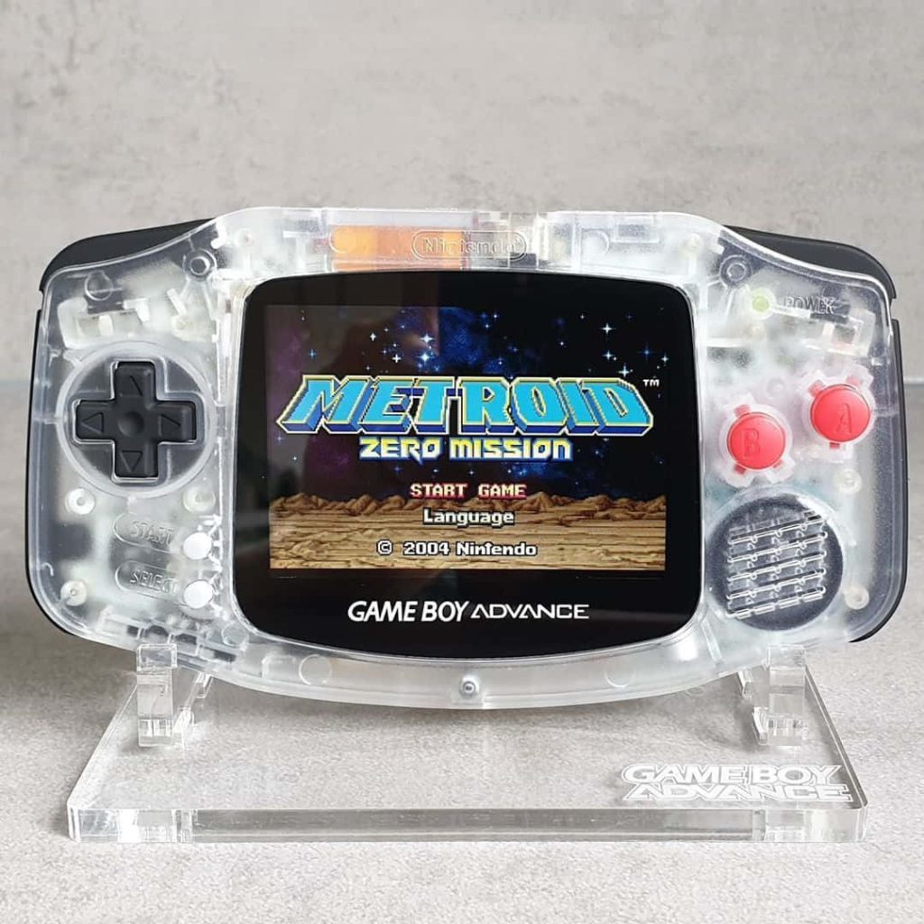 Transparent Nintendo Game Boy Advance showing Metroid Zero Mission title screen on display stand Wallpaper