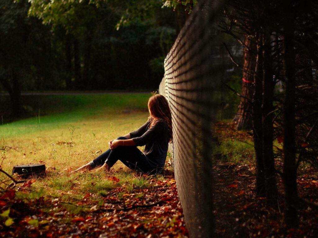Grief-stricken girl finds solace in the mystical depths of the forest Wallpaper