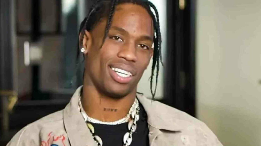 Mysterious Melancholy: Travis Scott Enveloped in Hazy Tones, Donning Elegant Black and Brown Attire Wallpaper