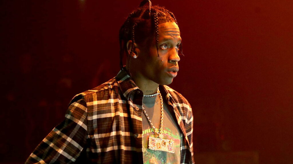 Bold Checkered Statement: Travis Scott Rocks a Stylish Brown Background Wallpaper