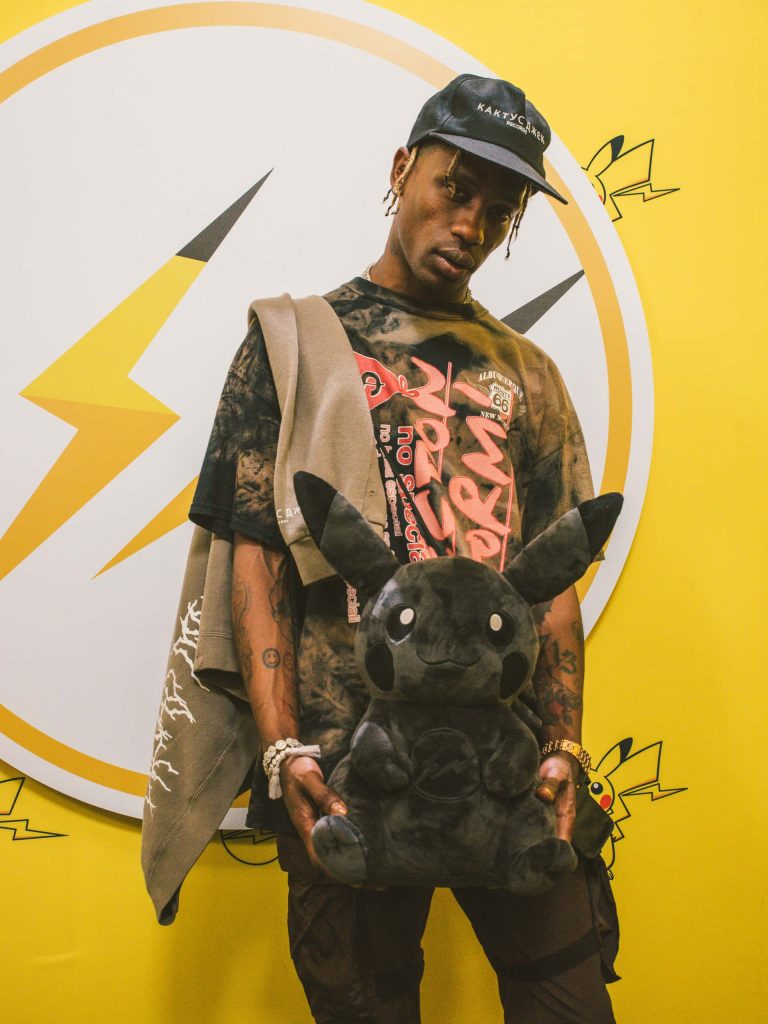 Travis Scott streetstyle portrait wearing Cactus Jack cap holding rare black fragment Pikachu plush Wallpaper