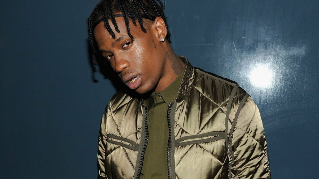 Travis Scott's Bold Transformation: A Mesmerizing HD Wallpaper of the Iconic Rapper Sporting Braided Hair and a Green Shiny Dress