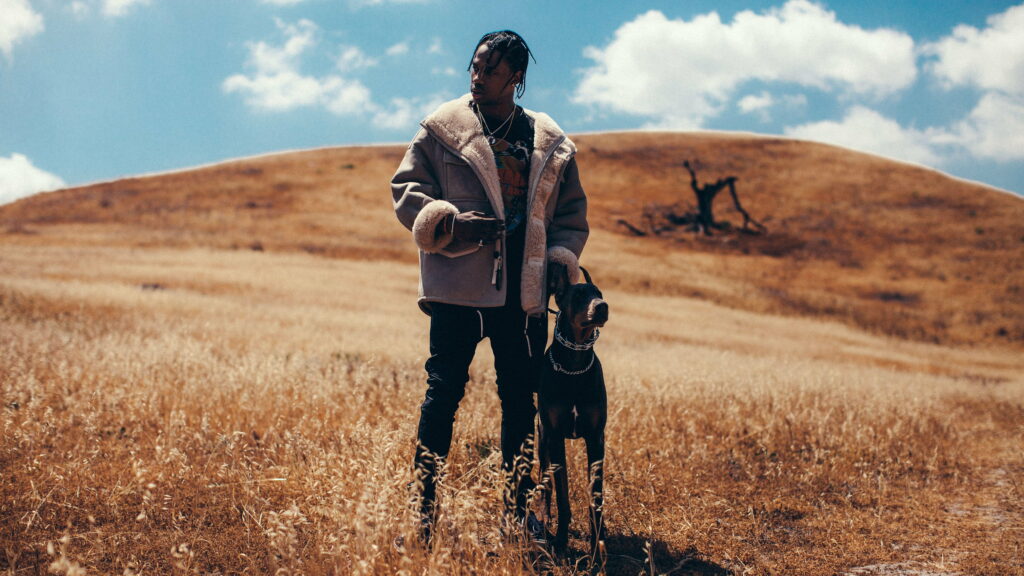 Sky-High Canine Companion: Travis Scott and Dog Take Center Stage in Dreamy Wallpaper