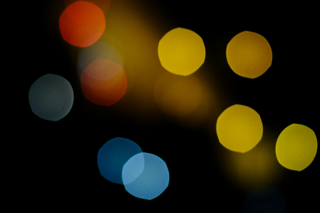 Tri-Color Bokeh Bliss: Blue, Yellow, and Red Lights Illuminate This Stunning Wallpaper Background