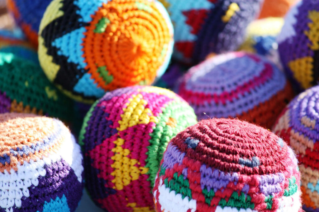 Triangular Crochet Delight: Captivating Colors in a Hacky Sack Dream Wallpaper