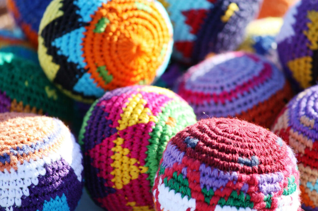 Triangular Crochet Delight: Captivating Colors in a Hacky Sack Dream Wallpaper