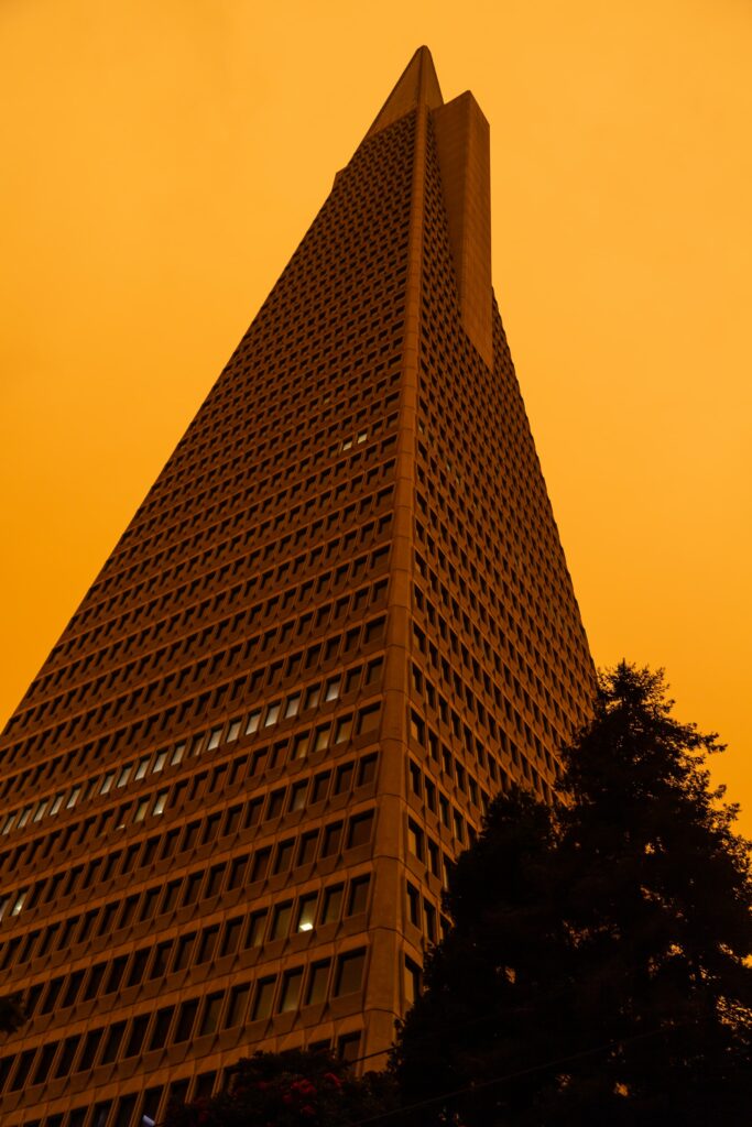 Triangular Facade Building Against Orange Sky - Modern Wallpaper Background