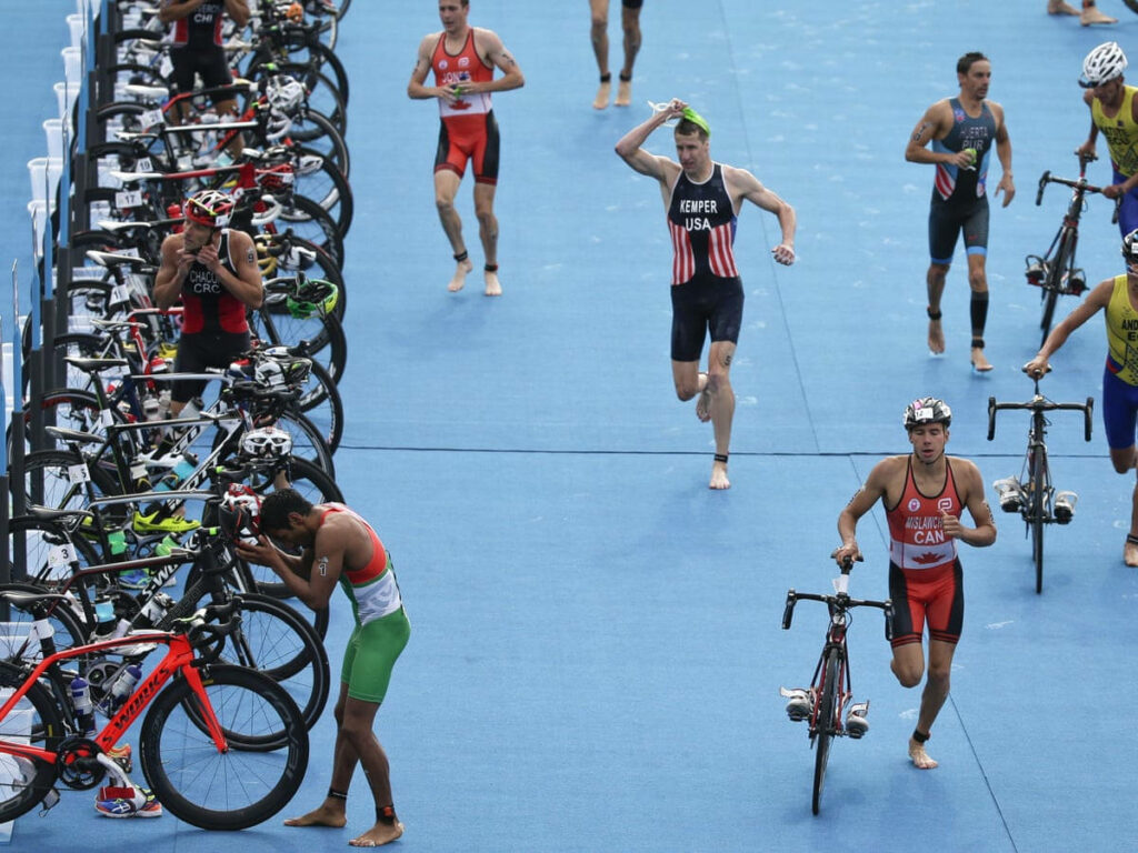 Triathlon Transition: Athletes Retrieve Bikes at Cycling Station Wallpaper
