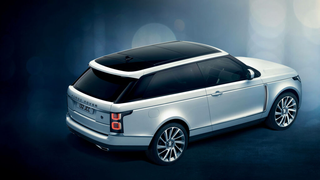 Trinity Land Rover Range Rover on Sleek Black Surface: Striking 4k Background Image Wallpaper