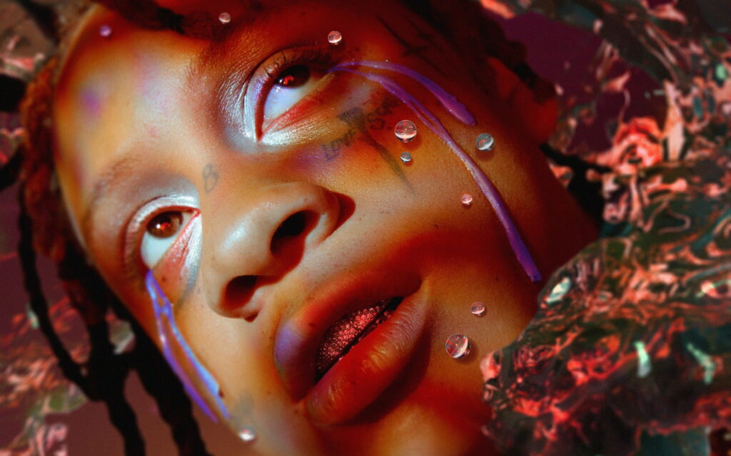 Close-up portrait of Trippie Redd with purple liquid tears jeweled grills moody red violet lighting Wallpaper