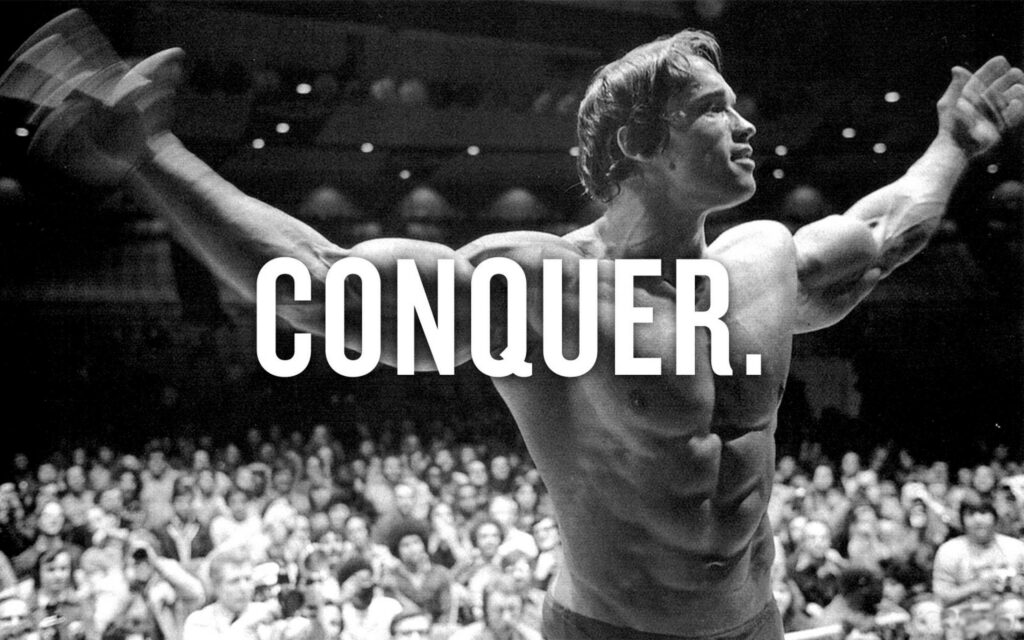 Conquer: Arnold Schwarzenegger's Inspiring Black-and-White Wallpaper