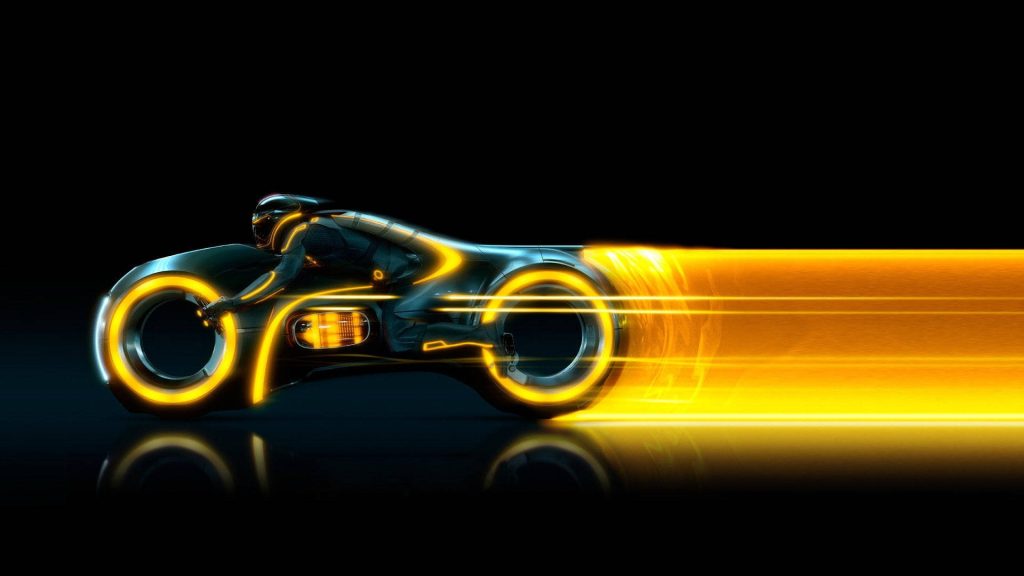 Futuristic Tron Light Cycle with yellow neon trails on reflective black background wallpaper
