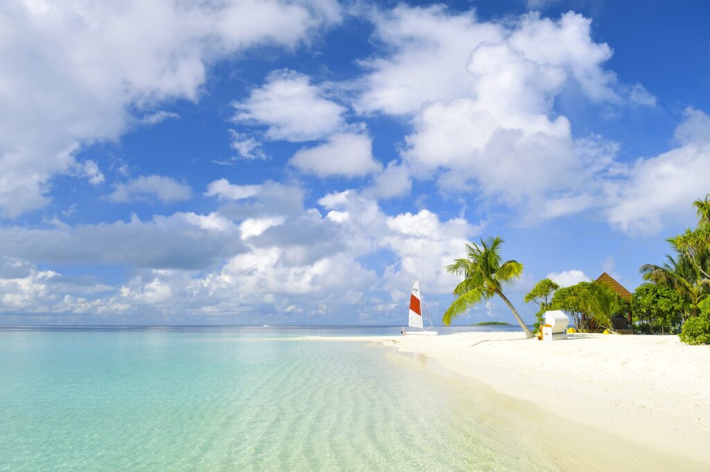 Tropical beach wallpaper with turquoise sea white sand palm trees lighthouse and yacht background
