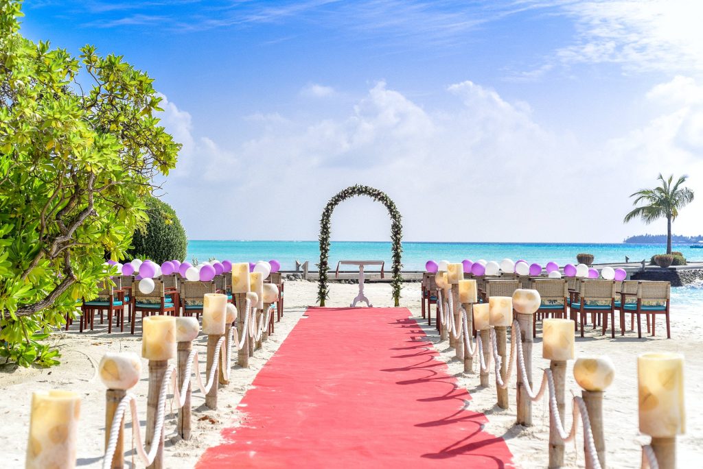 Tropical beach wedding wallpaper with floral altar bamboo lanterns balloons turquoise ocean sky
