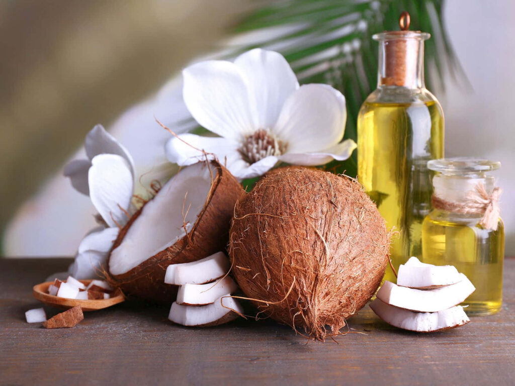 Vibrant coconut wallpaper with whole and sliced coconuts glass bottles and tropical leaves