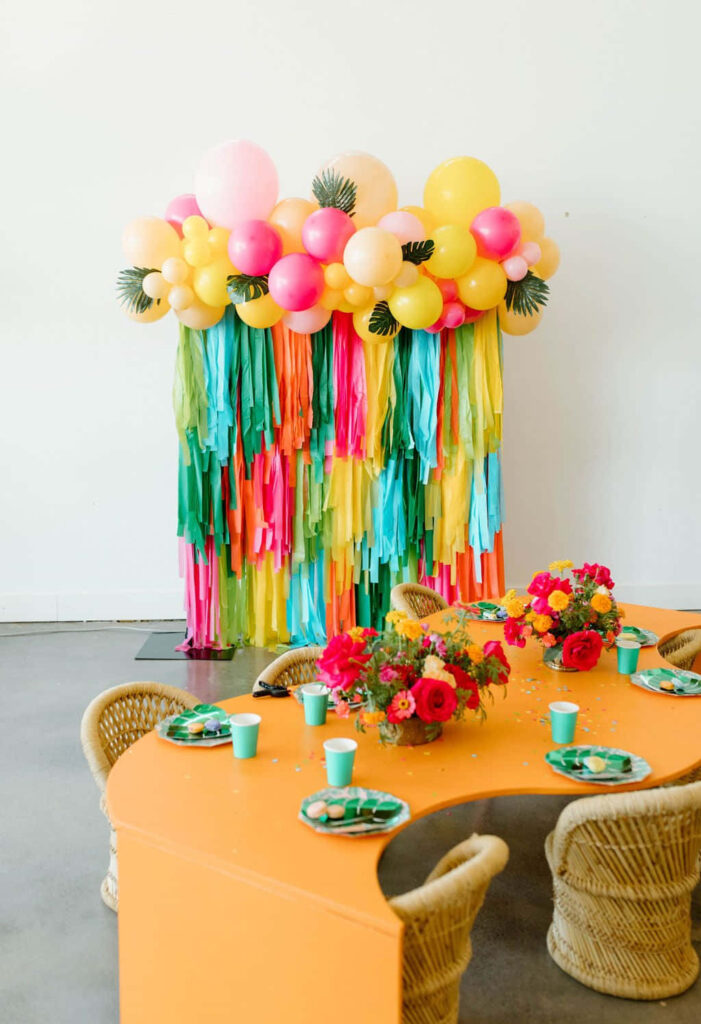 Festive luau party scene with tropical balloons streamers bright flowers and colorful tableware Wallpaper