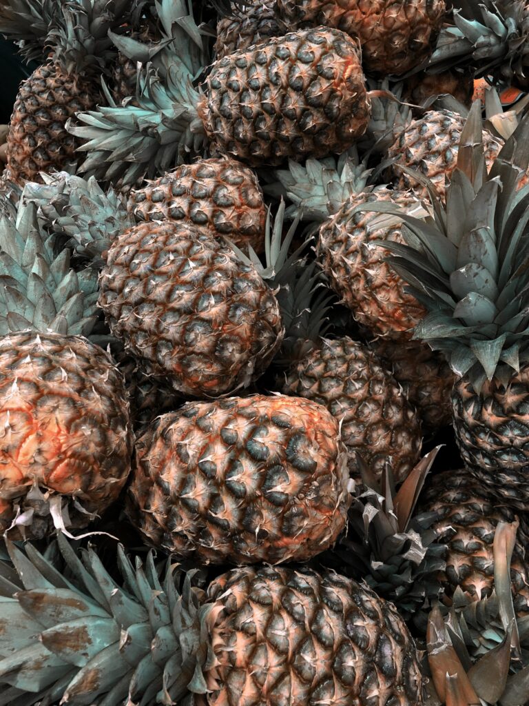 Tropical Pineapple Wallpaper: Lush Green Leaves & Refreshing Vibe