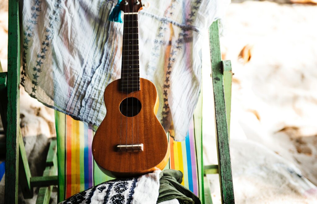 Tropical Vibe Wallpaper: Acoustic Guitar on Colorful Striped Chair