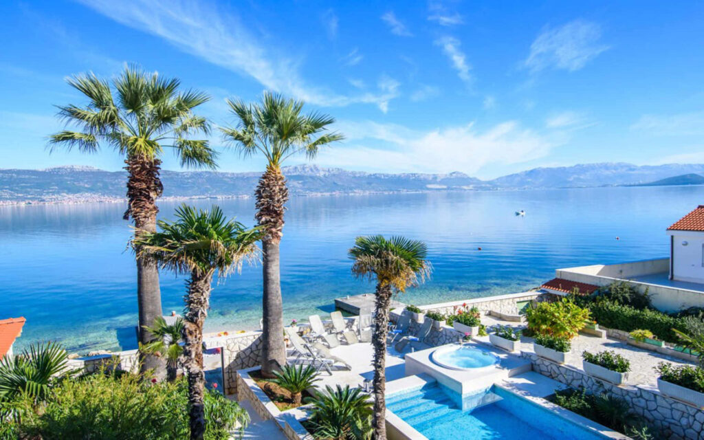 Tranquil Tropical Wallpaper: Lush Palm Trees and Pristine Beach