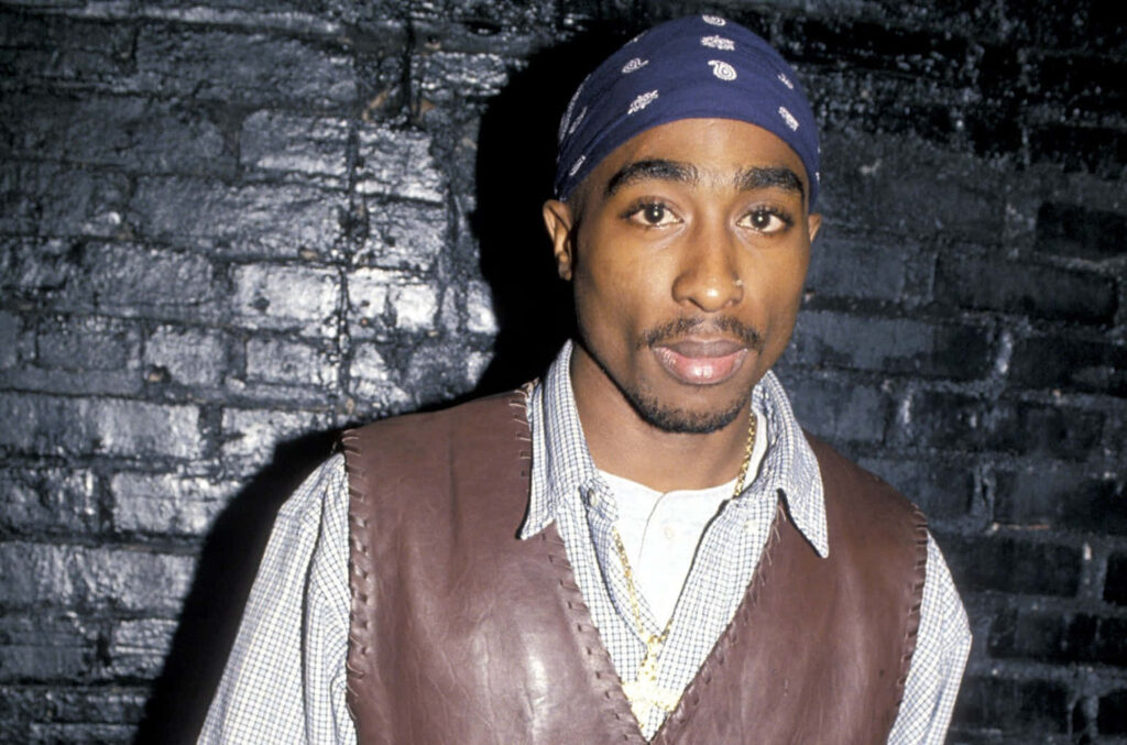 Unbreakable Spirit: Tupac Shakur's Defiance Transcends Boundaries Wallpaper