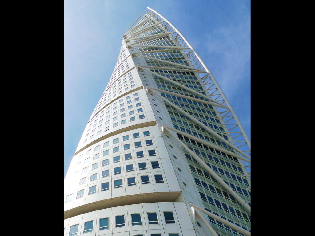 Turning Torso skyscraper twisting design against bright blue sky modern architecture wallpaper