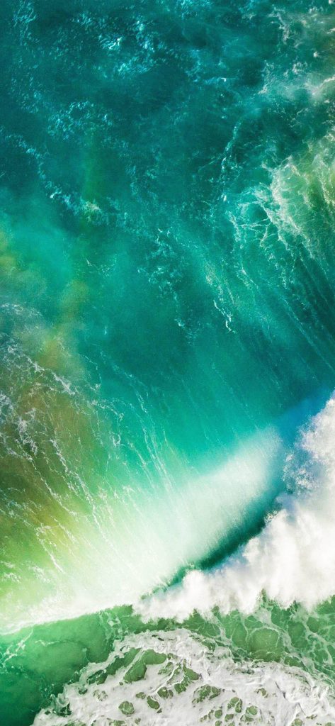 Aerial view of turquoise ocean wave with white foam iPhone wallpaper background nature aesthetic