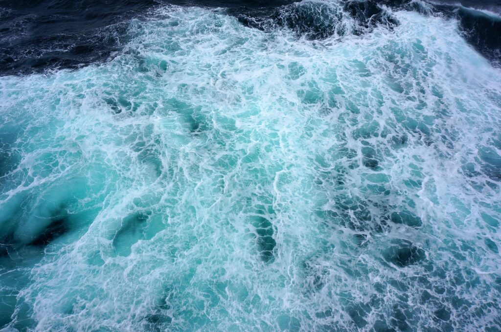 High-resolution ocean wallpaper with crashing waves vibrant turquoise and deep blue textured foam