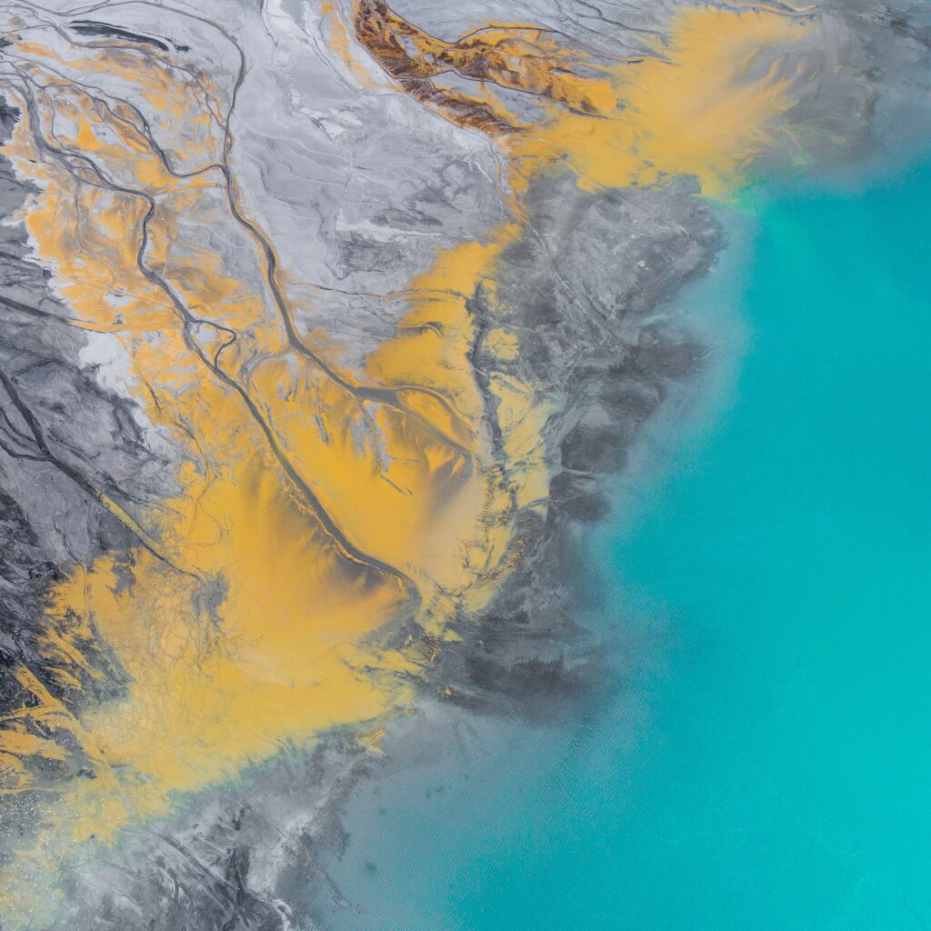 Aerial view of Polish lake with turquoise water and golden yellow abstract swirls wallpaper background
