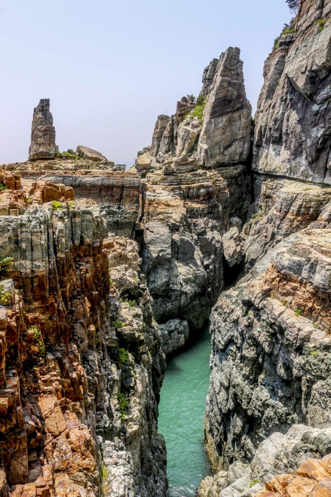 Towering rock formations and turquoise river in dramatic gorge landscape wallpaper background