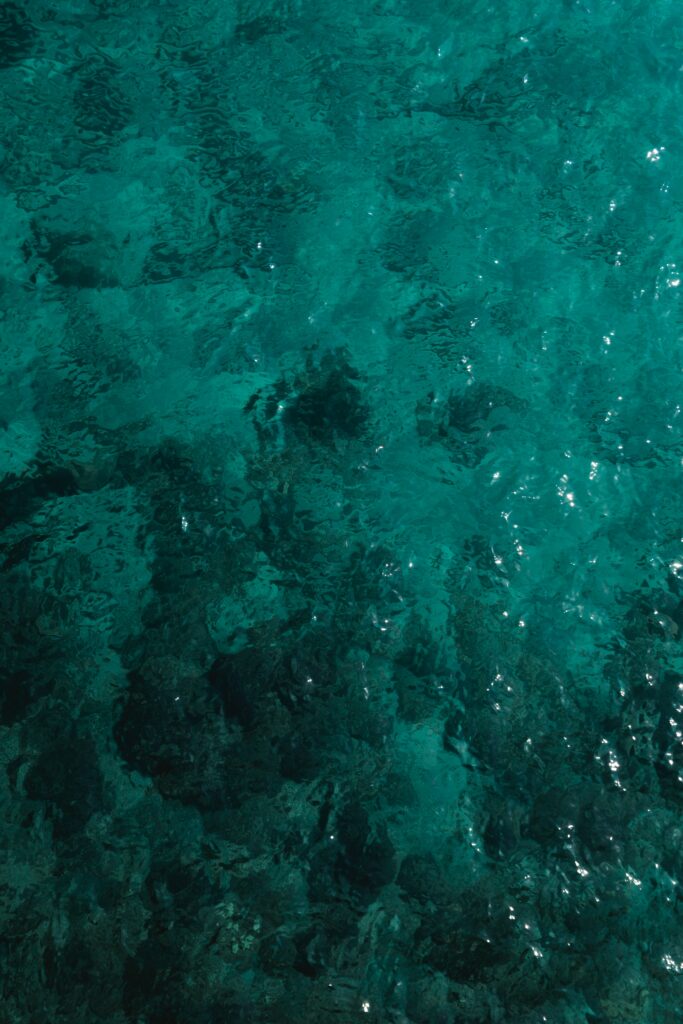 Turquoise water wallpaper with clear ripples and soft light reflections creating calm vibes