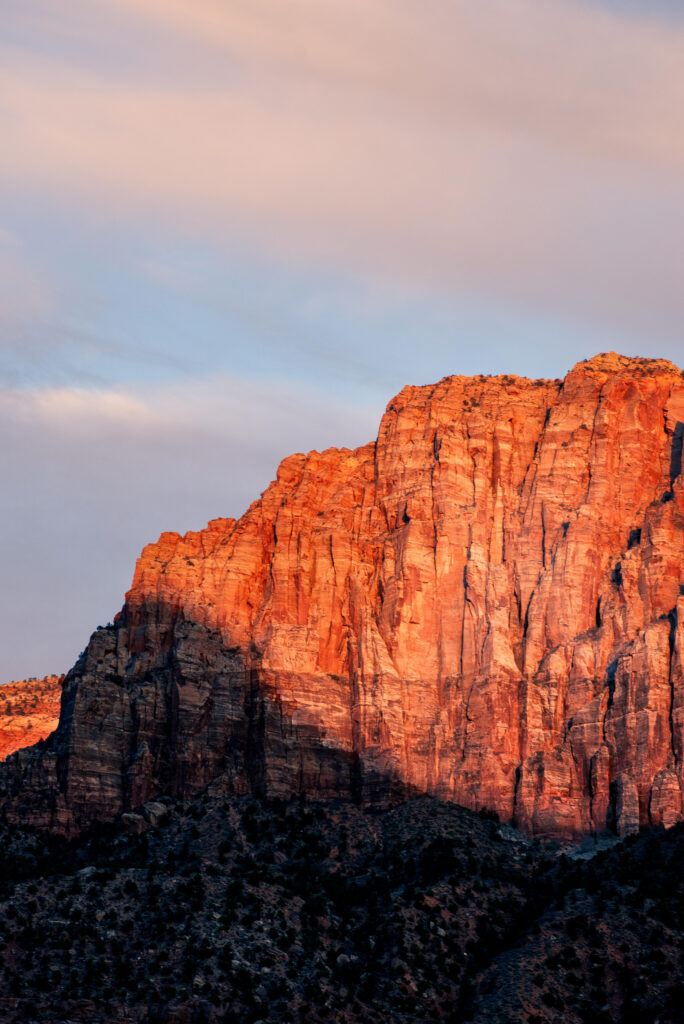 Twilight canyon landscape with glowing rugged rock formations and warm textured cliffs wallpaper