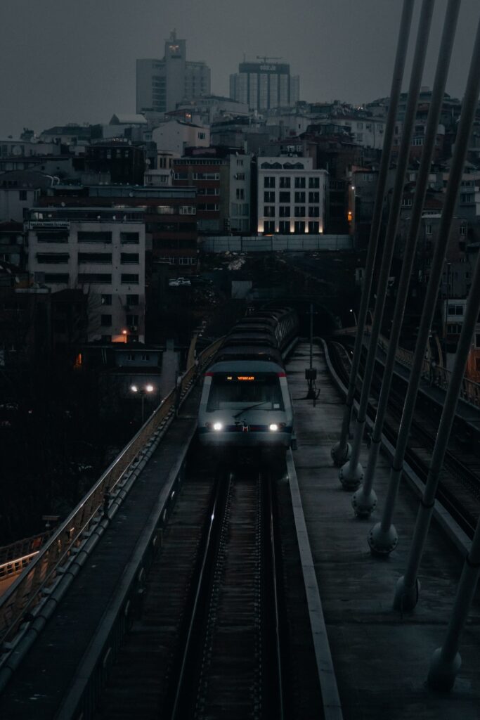 Twilight Cityscape Wallpaper: Modern Train & Silhouetted Buildings