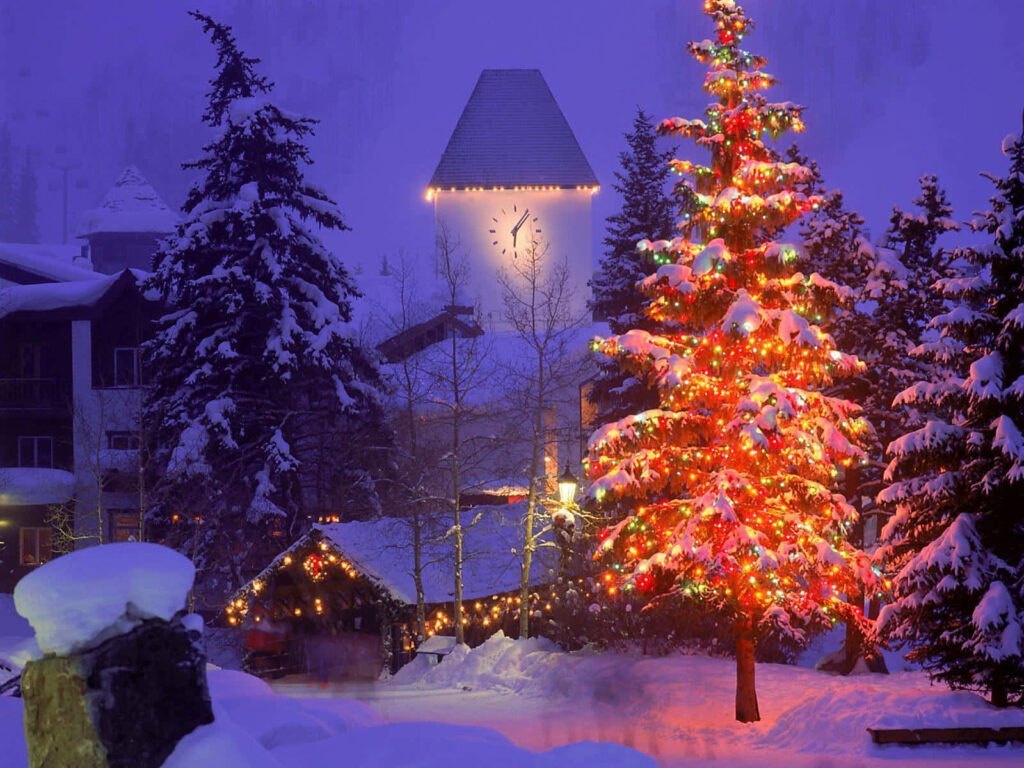 Twilight Snowy Village with Festive Christmas Tree & Cozy Cottages Wallpaper