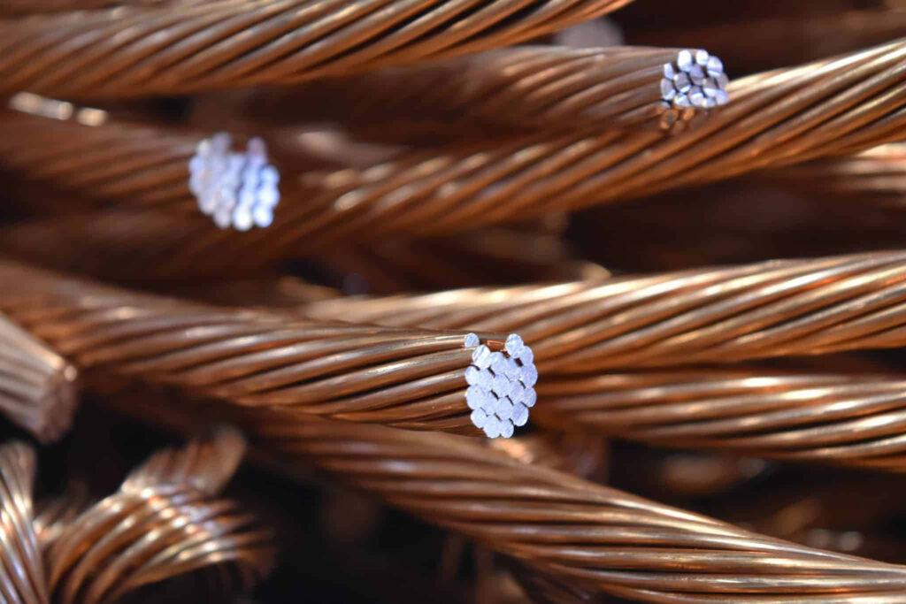 Close-up of twisted copper wire strands with metallic sheen and rich reddish-brown texture background Wallpaper