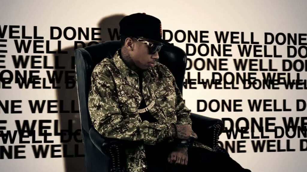 Confident Tyga Wallpaper: Bold Chair & 'Well Done' Backdrop