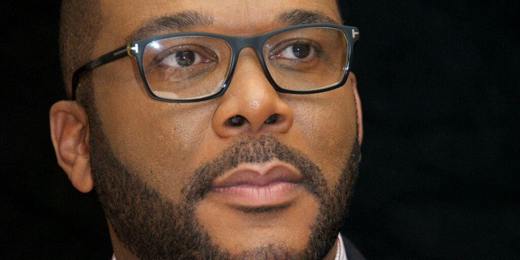 Tyler Perry close-up portrait with glasses and beard on dark background wallpaper image