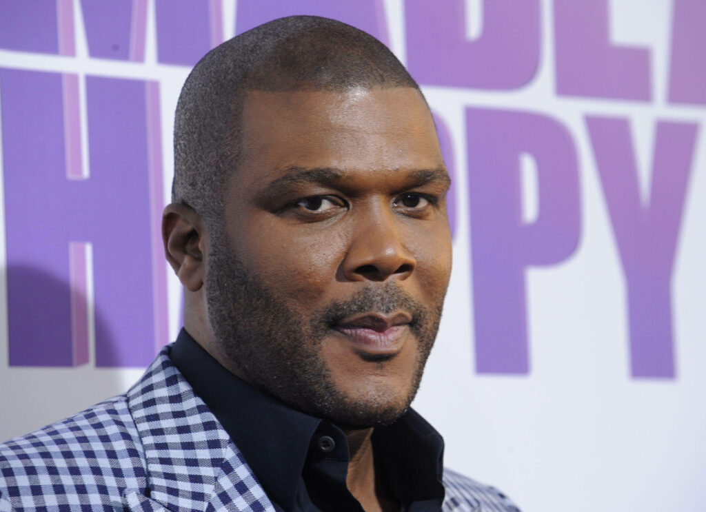 Tyler Perry stylish confident pose vibrant colorful wallpaper background for desktop display