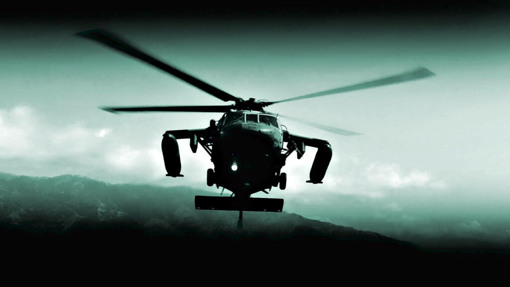 US Army Black Hawk helicopter flying over mountains showing military strength and aviation skills Wallpaper