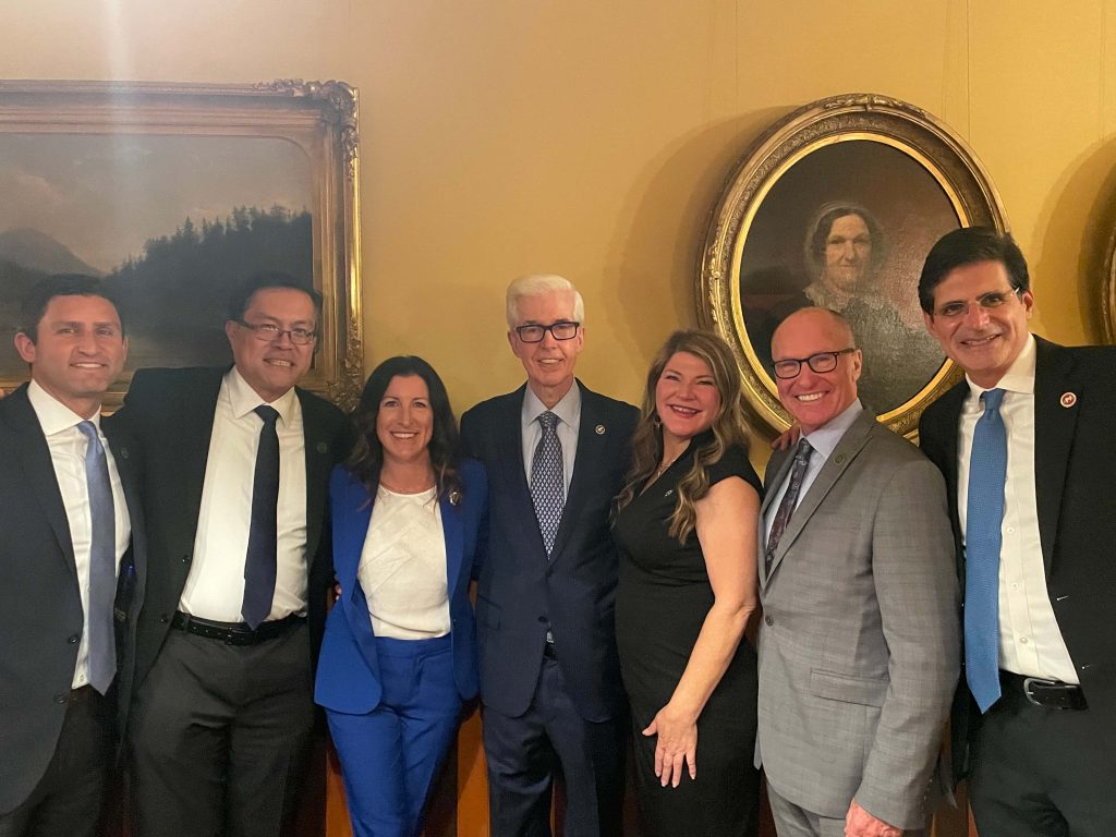 U.S. Senator John Cornyn with colleagues in formal office with historic art yellow walls Wallpaper