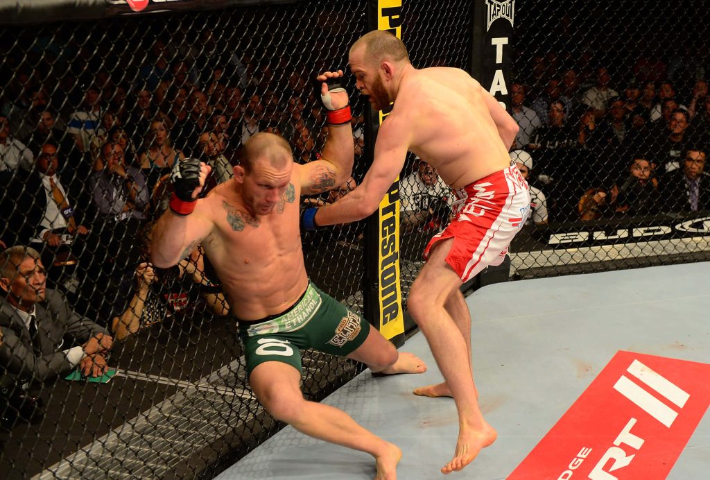 UFC 160 fight T.J Grant punches Gray Maynard in Octagon bright arena MMA action wallpaper